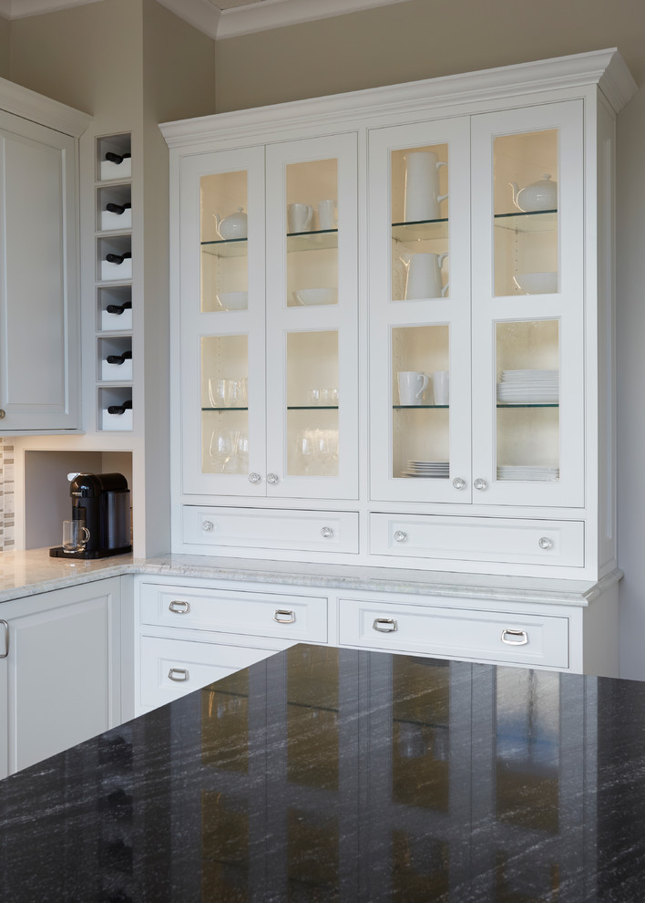 Open concept kitchen - mid-sized transitional u-shaped dark wood floor open concept kitchen idea in Chicago with an undermount sink, raised-panel cabinets, white cabinets, quartz countertops, multicolored backsplash, matchstick tile backsplash, stainless steel appliances and an island