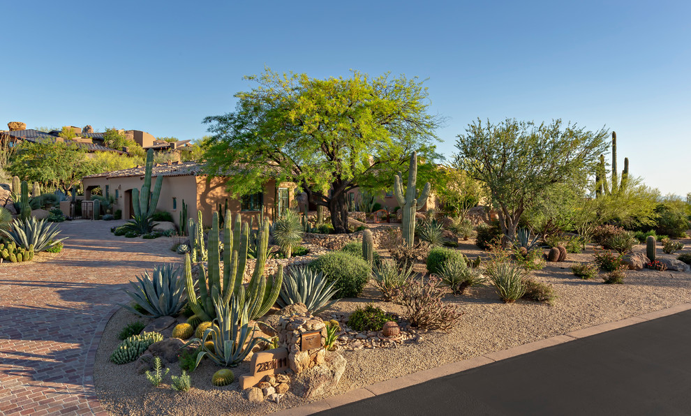 Large front yard xeriscape in Phoenix with a garden path and brick pavers.