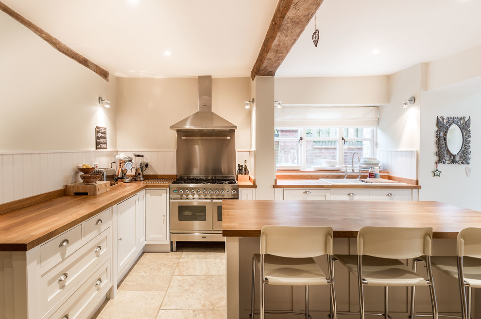 Country l-shaped kitchen in Buckinghamshire with with island and wood benchtops.