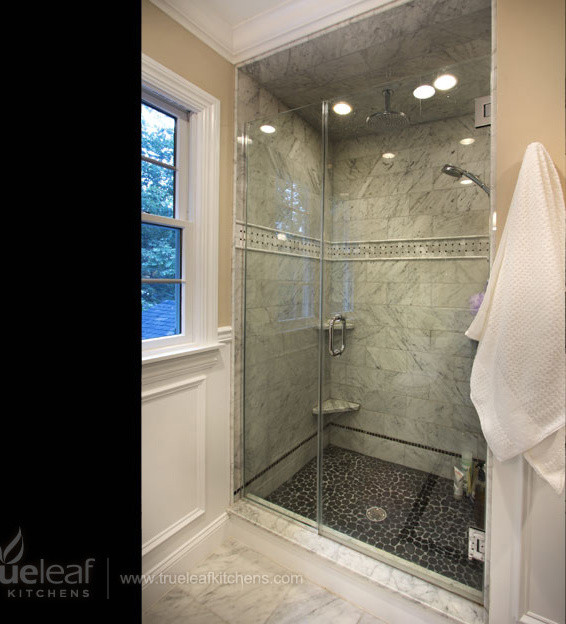 Design ideas for a large transitional master bathroom in New York with an alcove shower, gray tile, stone tile, beige walls and pebble tile floors.