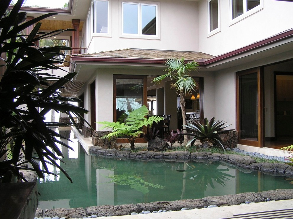 Design ideas for a large tropical side yard full sun garden in Hawaii with a water feature and natural stone pavers.
