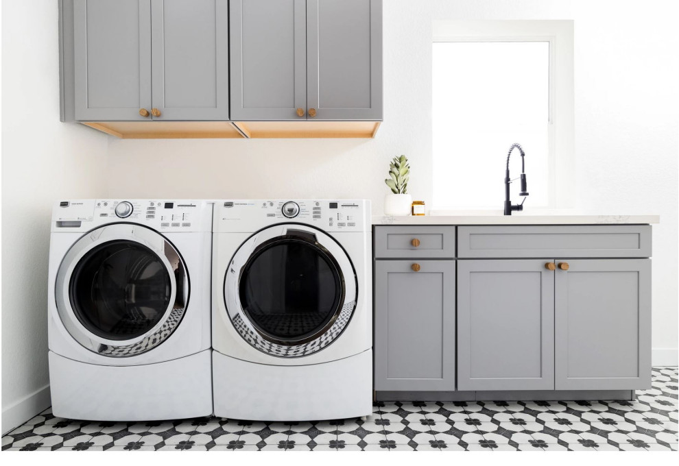 This is an example of a small transitional single-wall dedicated laundry room in Phoenix with an undermount sink, shaker cabinets, grey cabinets, white walls, a side-by-side washer and dryer, multi-coloured floor and white benchtop.