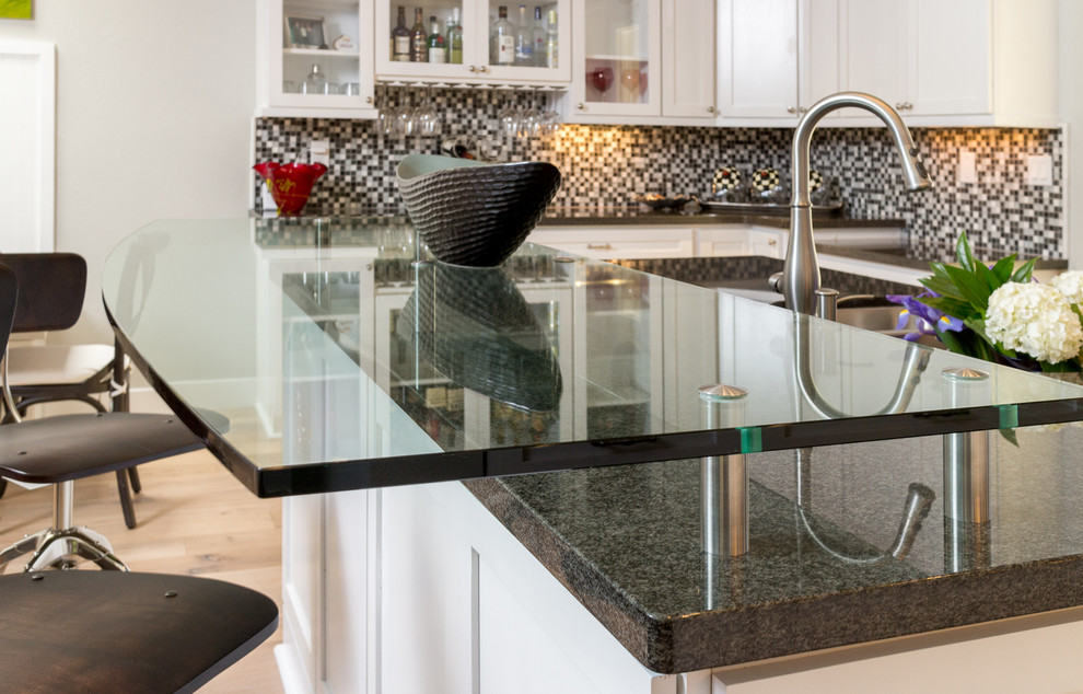 Open concept kitchen - huge transitional u-shaped light wood floor open concept kitchen idea in Phoenix with a farmhouse sink, shaker cabinets, white cabinets, granite countertops, white backsplash, glass tile backsplash, stainless steel appliances and an island