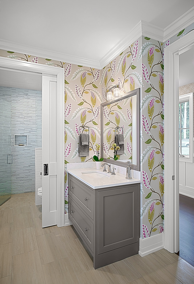 Mid-sized elegant blue tile and glass tile ceramic tile, brown floor, single-sink and wallpaper walk-in shower photo in Grand Rapids with shaker cabinets, gray cabinets, multicolored walls, an undermount sink, quartz countertops, a hinged shower door, white countertops and a built-in vanity