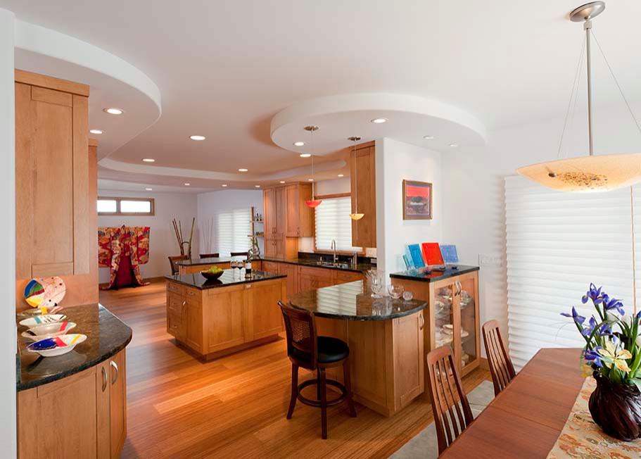 Design ideas for a large transitional u-shaped eat-in kitchen in Hawaii with an undermount sink, shaker cabinets, medium wood cabinets, granite benchtops, multi-coloured splashback, granite splashback, panelled appliances, bamboo floors, with island, brown floor, multi-coloured benchtop and recessed.