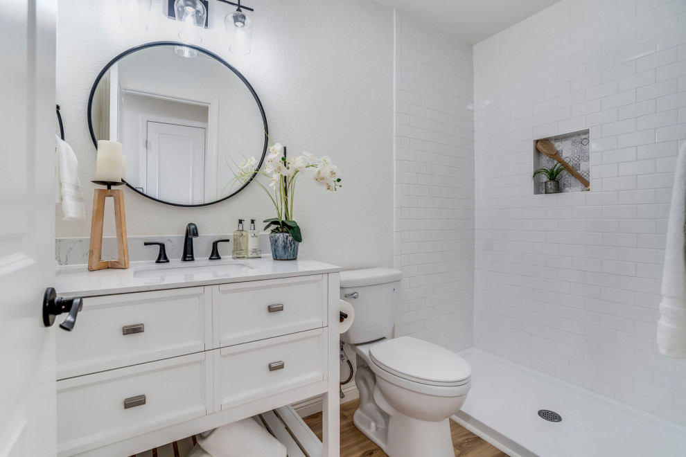 This is an example of a beach style bathroom in San Diego with shaker cabinets, white cabinets, quartzite benchtops, a single vanity and a freestanding vanity.