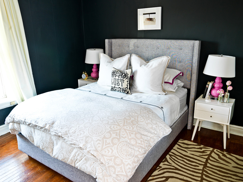 This is an example of a contemporary bedroom in Chicago with black walls.