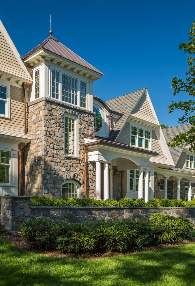 Inspiration for an expansive traditional three-storey beige exterior in Boston with stone veneer and a gable roof.