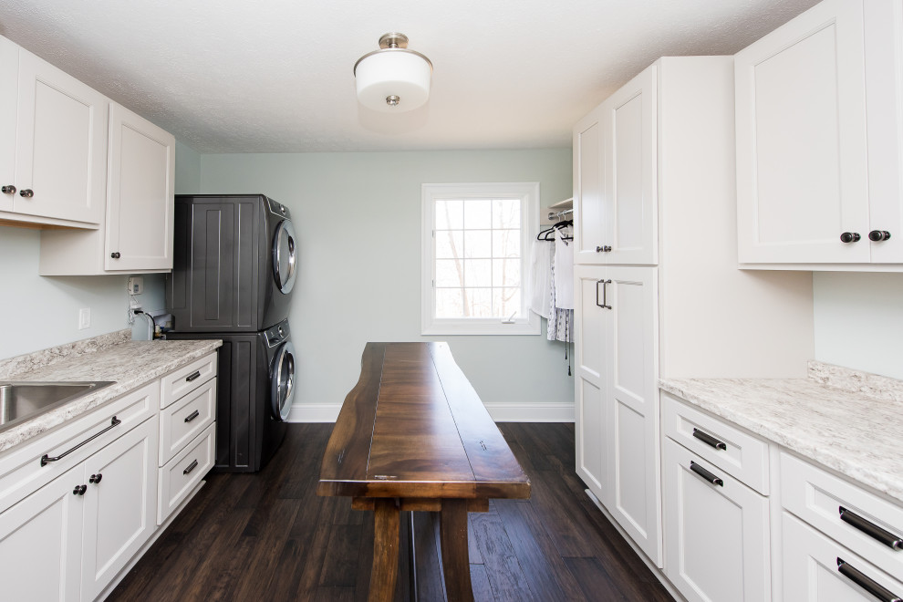Mid-sized midcentury galley dedicated laundry room in Indianapolis with an undermount sink, recessed-panel cabinets, white cabinets, granite benchtops, dark hardwood floors and white benchtop.