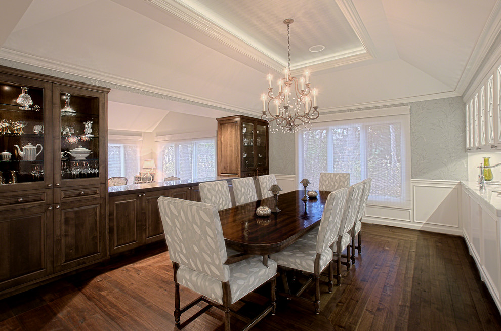 This is an example of a large traditional separate dining room in Chicago with grey walls, dark hardwood floors, brown floor, recessed and wallpaper.