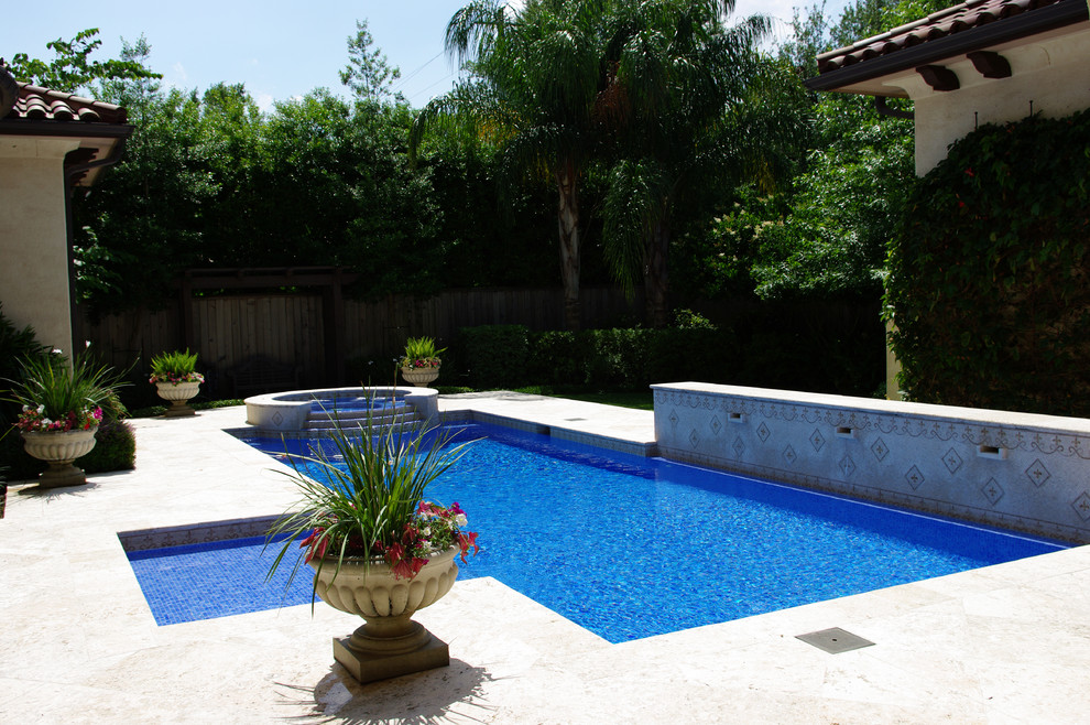 Mid-sized mediterranean backyard rectangular lap pool in Houston with a hot tub.