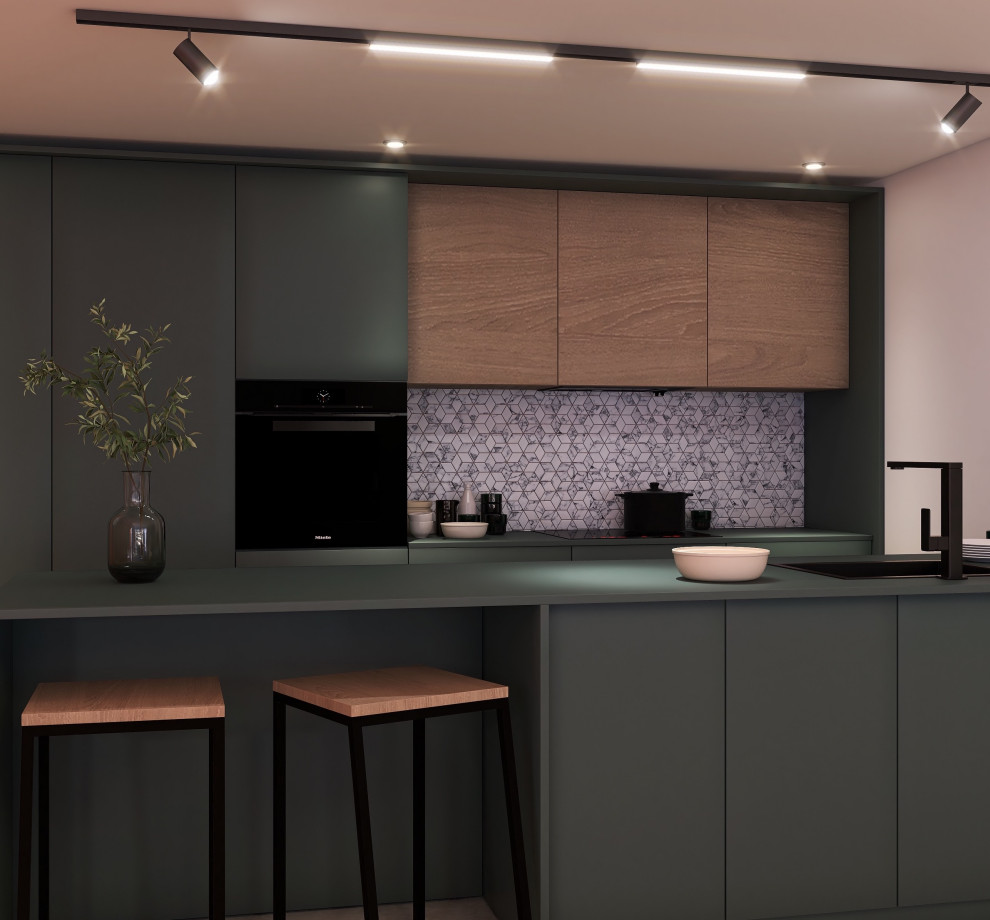 Cette image montre une cuisine américaine parallèle minimaliste avec des portes de placards vertess, un électroménager noir, îlot et un plan de travail vert.