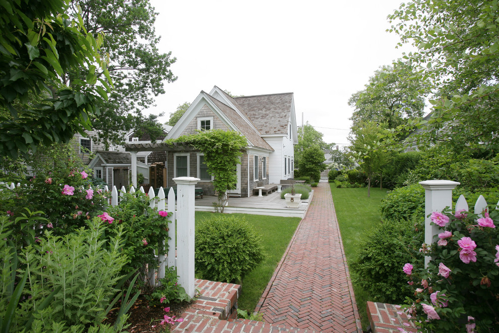 Inspiration for a traditional full sun garden in Boston with a garden path and brick pavers.