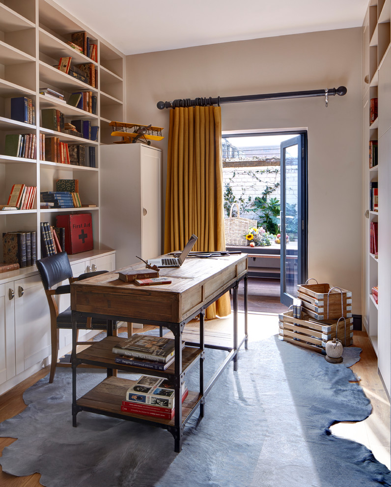This is an example of a transitional study room in London with a freestanding desk.