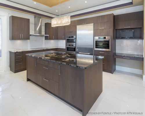 Open concept kitchen - mid-sized modern l-shaped ceramic tile open concept kitchen idea in Vancouver with flat-panel cabinets, dark wood cabinets, granite countertops, white backsplash, ceramic backsplash, stainless steel appliances and an island
