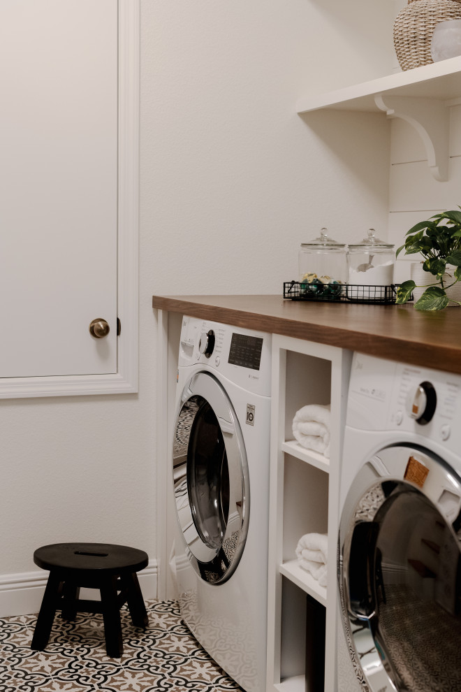 Inspiration for a mid-sized transitional galley dedicated laundry room in Orlando with wood benchtops, white splashback, shiplap splashback, white walls, ceramic floors, a side-by-side washer and dryer, multi-coloured floor, brown benchtop and planked wall panelling.