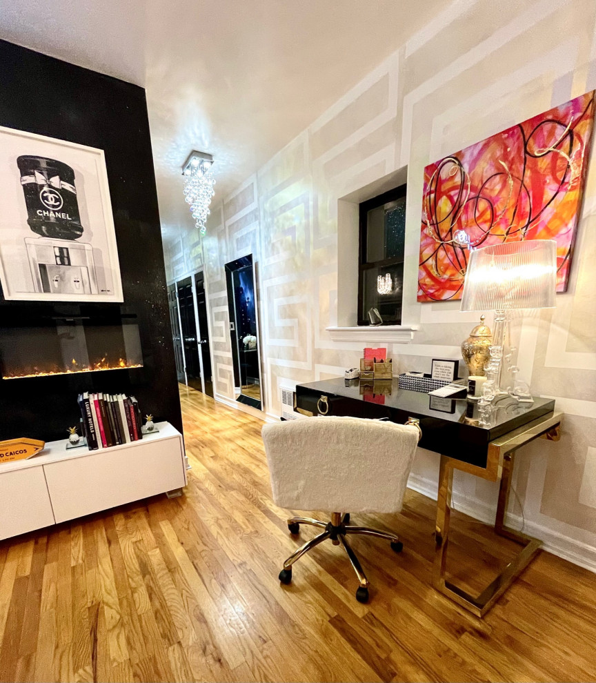 Example of a small minimalist freestanding desk medium tone wood floor study room design in New York with multicolored walls