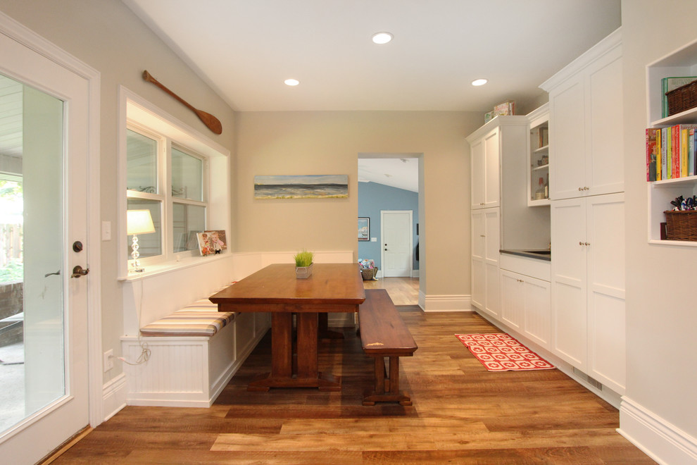 Kitchen/dining room combo - small country l-shaped kitchen/dining room combo idea in Grand Rapids with a farmhouse sink, shaker cabinets, white cabinets, quartz countertops, white backsplash, subway tile backsplash, stainless steel appliances, an island and beige walls
