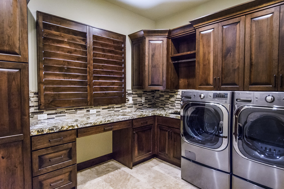 Mid-sized u-shaped dedicated laundry room in Salt Lake City with an undermount sink, raised-panel cabinets, dark wood cabinets, granite benchtops, white walls, ceramic floors and a side-by-side washer and dryer.