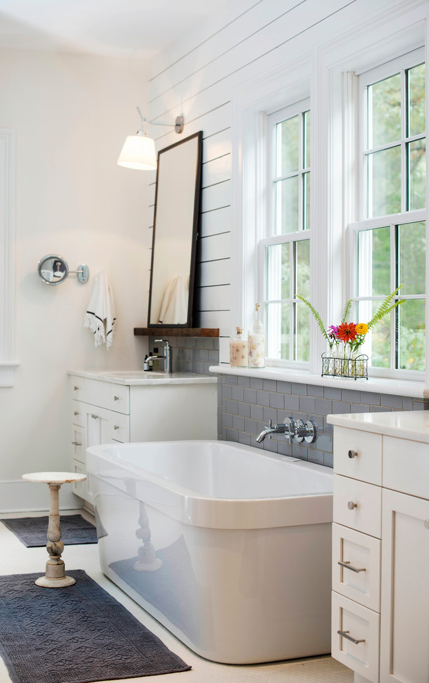 Design ideas for a large traditional master bathroom in Raleigh with an undermount sink, shaker cabinets, white cabinets, a freestanding tub, gray tile, subway tile, white walls and engineered quartz benchtops.