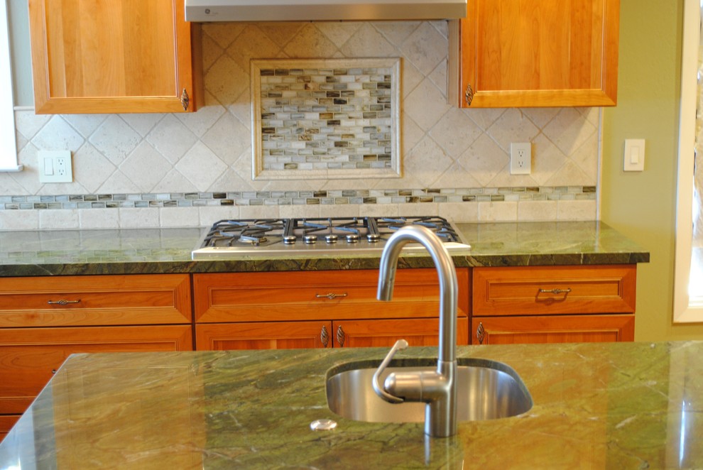 Mid-sized transitional u-shaped light wood floor eat-in kitchen photo in San Francisco with an undermount sink, shaker cabinets, light wood cabinets, granite countertops, beige backsplash, stainless steel appliances and an island