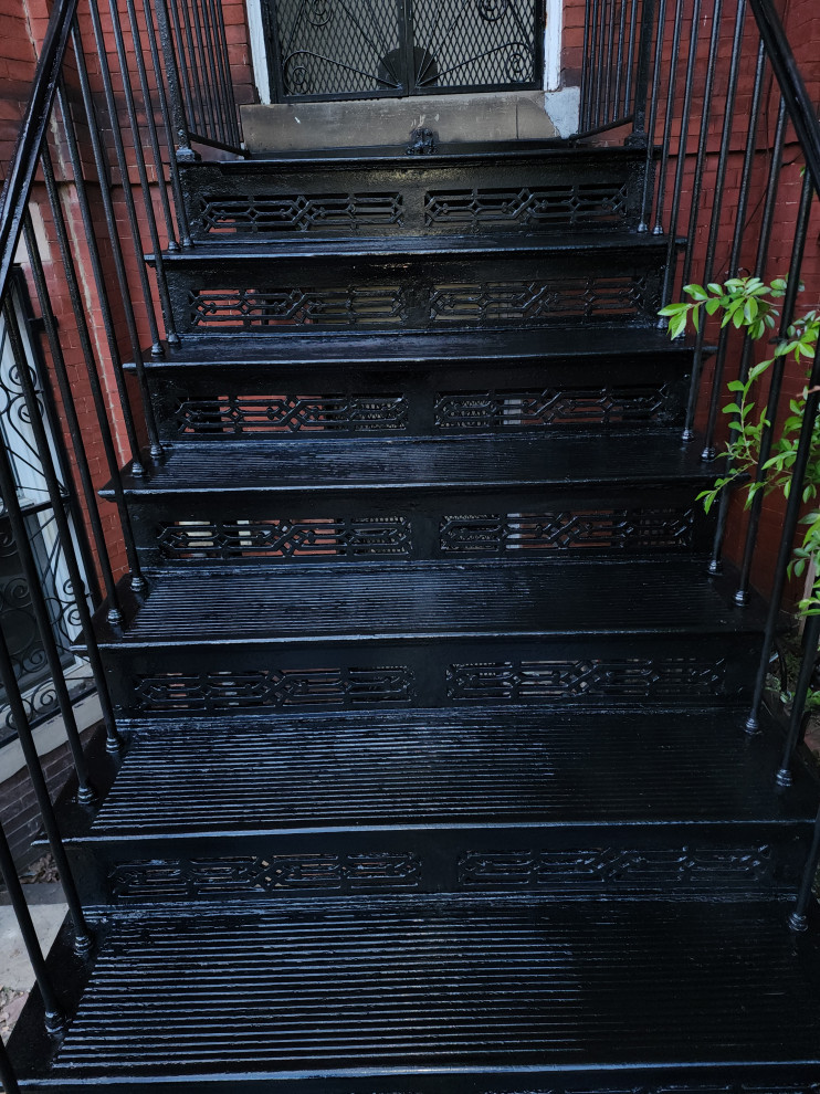 ワシントンD.C.にある高級な中くらいなトラディショナルスタイルのおしゃれなスケルトン階段 (金属の蹴込み板、金属の手すり、レンガ壁) の写真
