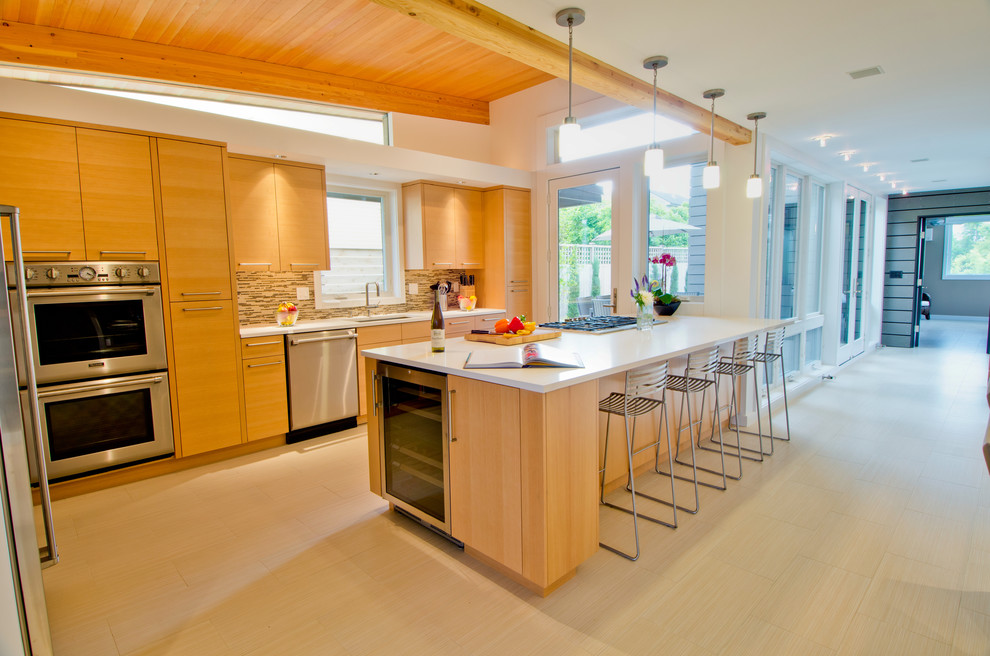Inspiration for a mid-sized contemporary galley eat-in kitchen in Seattle with an undermount sink, flat-panel cabinets, light wood cabinets, multi-coloured splashback, matchstick tile splashback, stainless steel appliances, stainless steel benchtops, light hardwood floors and with island.