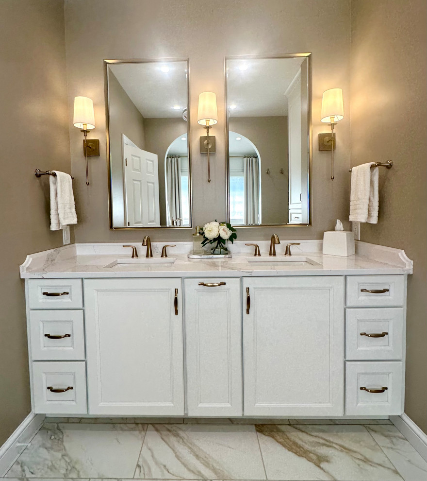 Freestanding bathtub - mid-sized transitional master white tile and marble tile porcelain tile, white floor, double-sink and wainscoting freestanding bathtub idea with recessed-panel cabinets, white cabinets, a two-piece toilet, brown walls, an undermount sink, quartz countertops, a hinged shower door, white countertops and a built-in vanity