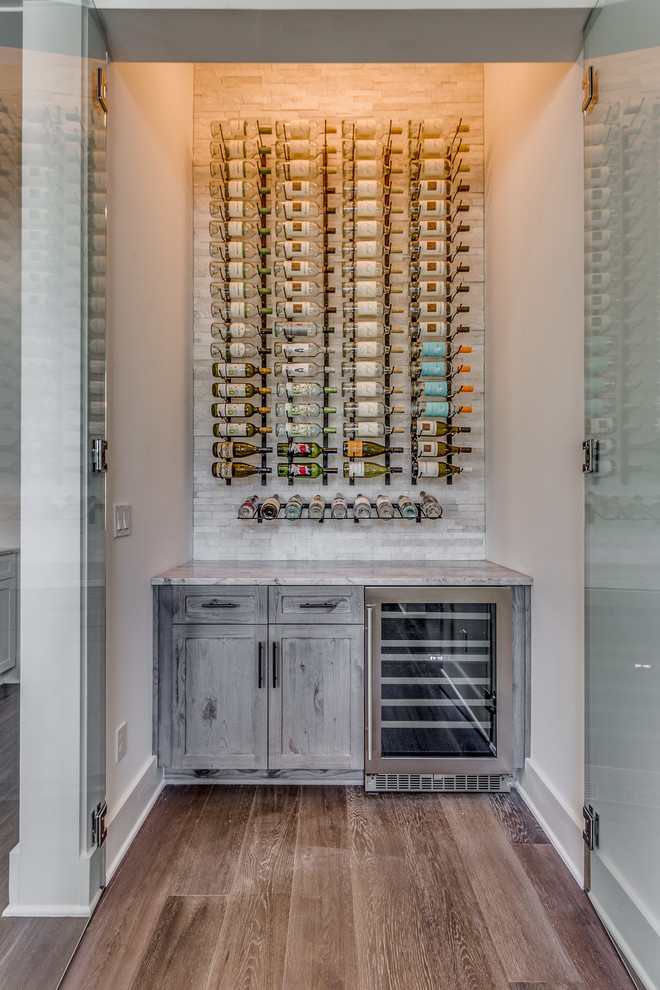 Transitional wine cellar in Jacksonville with dark hardwood floors, storage racks and brown floor.