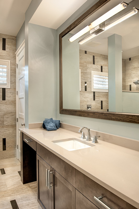 This is an example of a large arts and crafts master bathroom in Miami with an undermount sink, recessed-panel cabinets, dark wood cabinets, quartzite benchtops, a corner shower, a two-piece toilet, beige tile, ceramic tile, blue walls and ceramic floors.