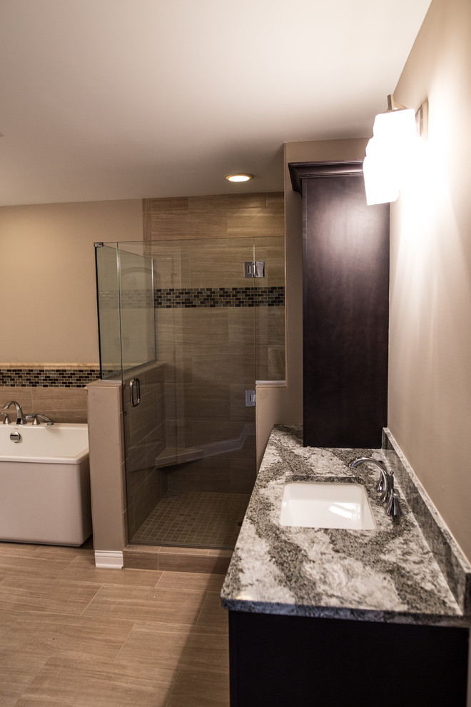 Inspiration for a mid-sized transitional master porcelain tile home design remodel in Chicago with black cabinets, brown walls, an undermount sink and granite countertops