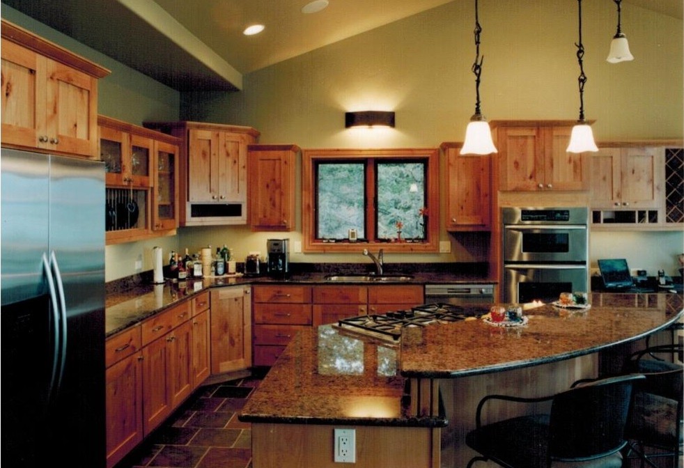 Kitchen - large rustic l-shaped slate floor kitchen idea with an undermount sink, shaker cabinets, light wood cabinets, granite countertops, stainless steel appliances and an island