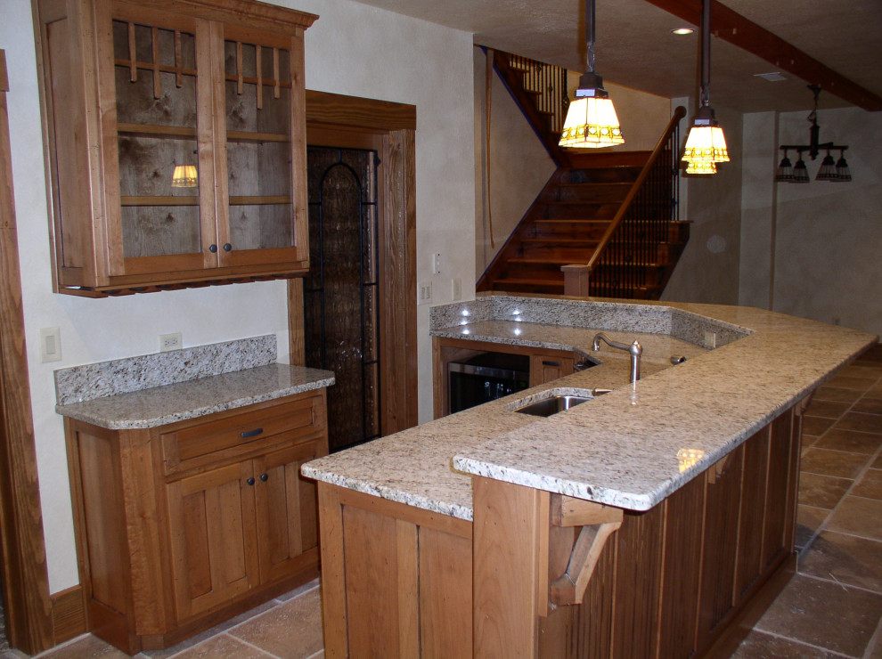Mid-sized l-shaped enclosed kitchen photo in Atlanta with raised-panel cabinets, granite countertops, beige backsplash, ceramic backsplash, stainless steel appliances, an island and beige countertops