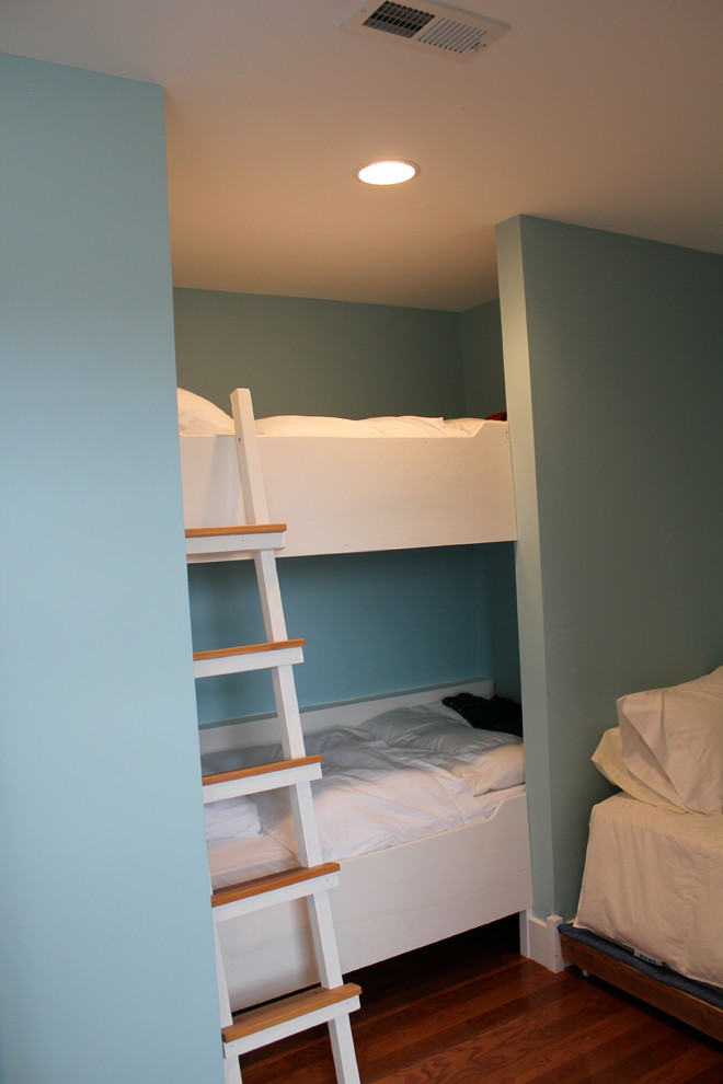 This is an example of a large beach style gender-neutral kids' room in Richmond with blue walls and dark hardwood floors.