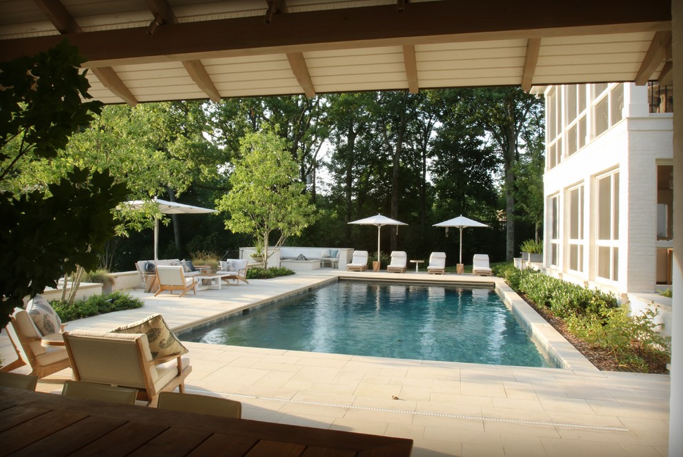 Example of a mid-sized transitional backyard stone and rectangular pool house design in Nashville