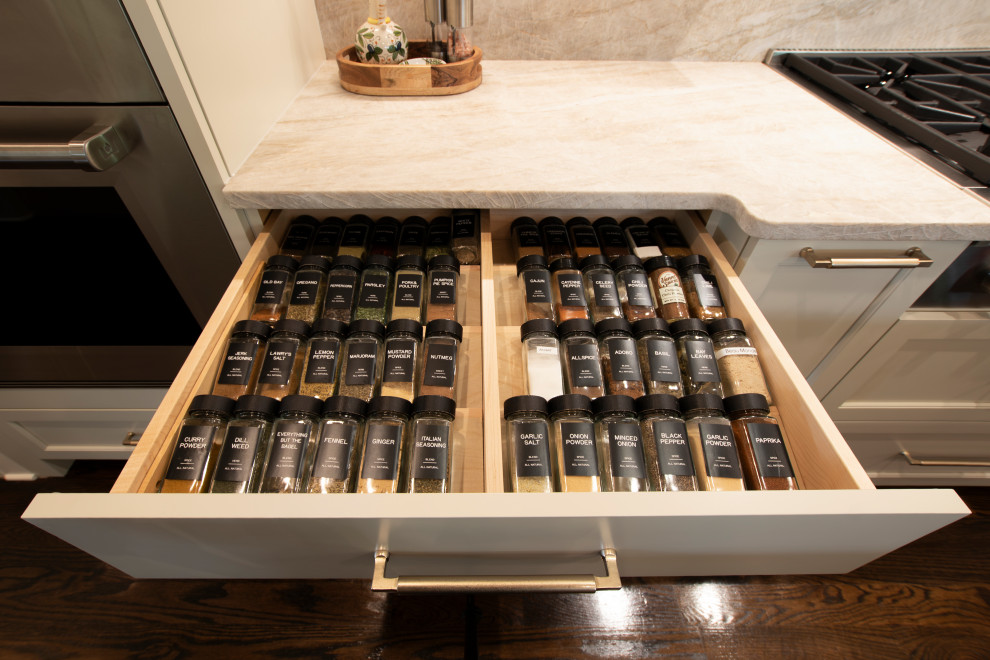 Inspiration for a large transitional l-shaped dark wood floor and brown floor open concept kitchen remodel in Nashville with an undermount sink, beaded inset cabinets, white cabinets, quartzite countertops, beige backsplash, stone slab backsplash, stainless steel appliances, an island and beige countertops
