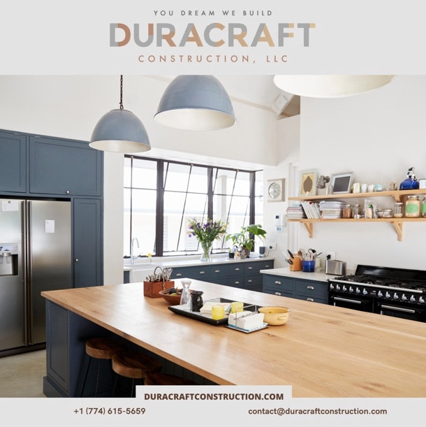 Large galley cement tile floor and gray floor eat-in kitchen photo with a farmhouse sink, blue cabinets, quartz countertops, black appliances, an island and white countertops