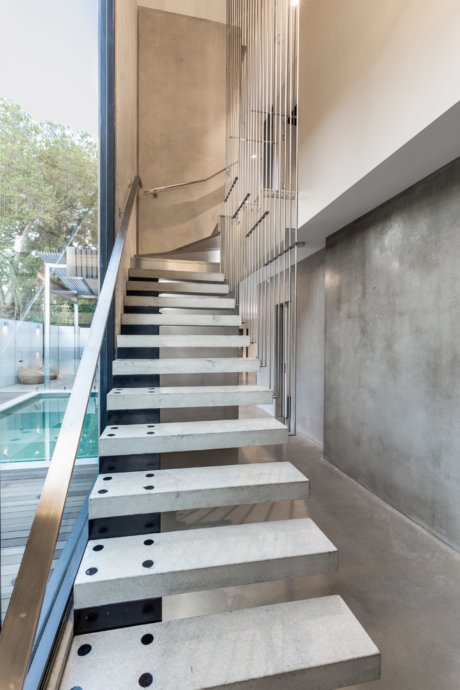 Design ideas for a mid-sized modern concrete floating staircase in Brisbane with open risers and metal railing.