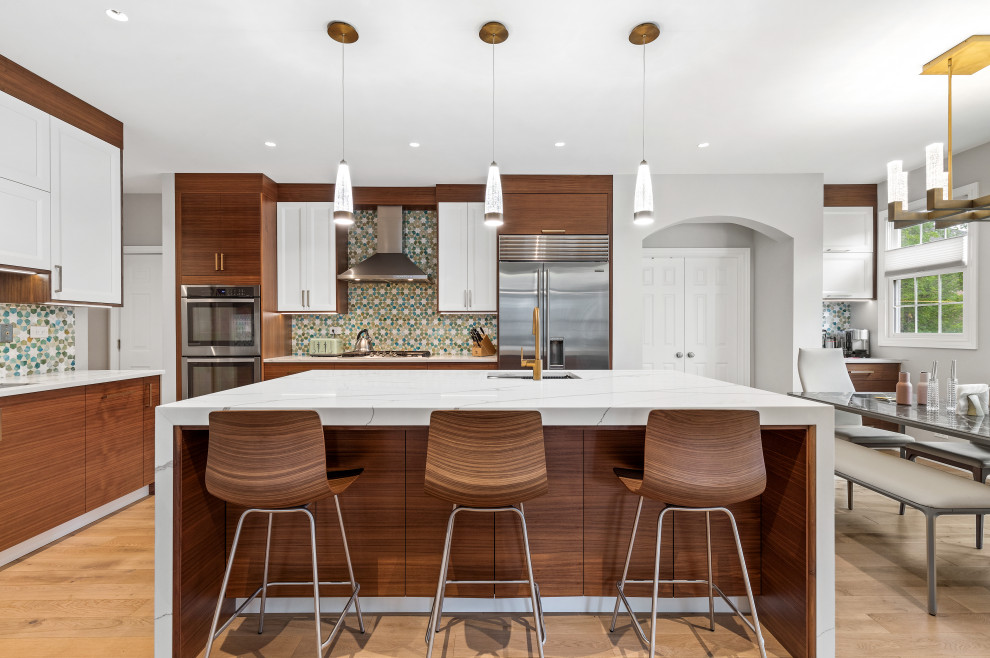 Inspiration for a large contemporary l-shaped eat-in kitchen in Chicago with an undermount sink, flat-panel cabinets, dark wood cabinets, quartz benchtops, multi-coloured splashback, stainless steel appliances, light hardwood floors, with island, yellow floor and white benchtop.