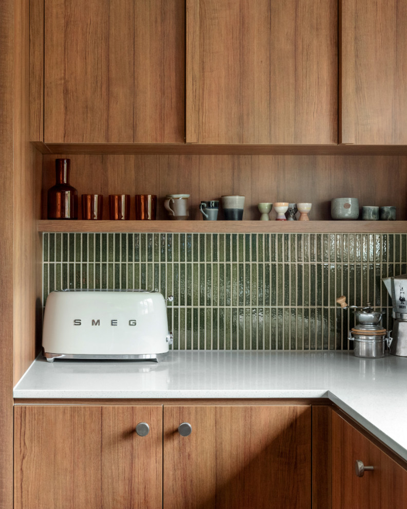 Design ideas for a large midcentury u-shaped eat-in kitchen in Melbourne with green splashback, ceramic splashback and stainless steel appliances.