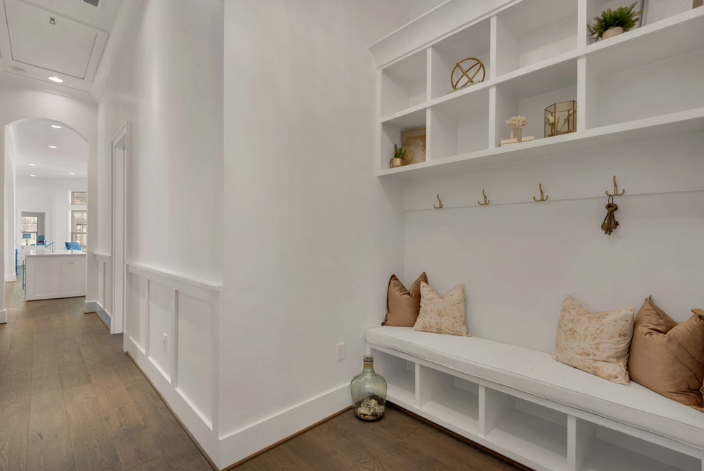 Large beach style mudroom in Other with white walls and medium hardwood floors.