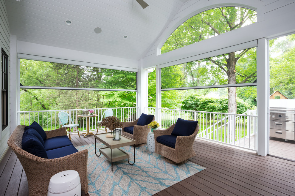 Photo of a large transitional backyard screened-in verandah in Minneapolis with decking and a roof extension.