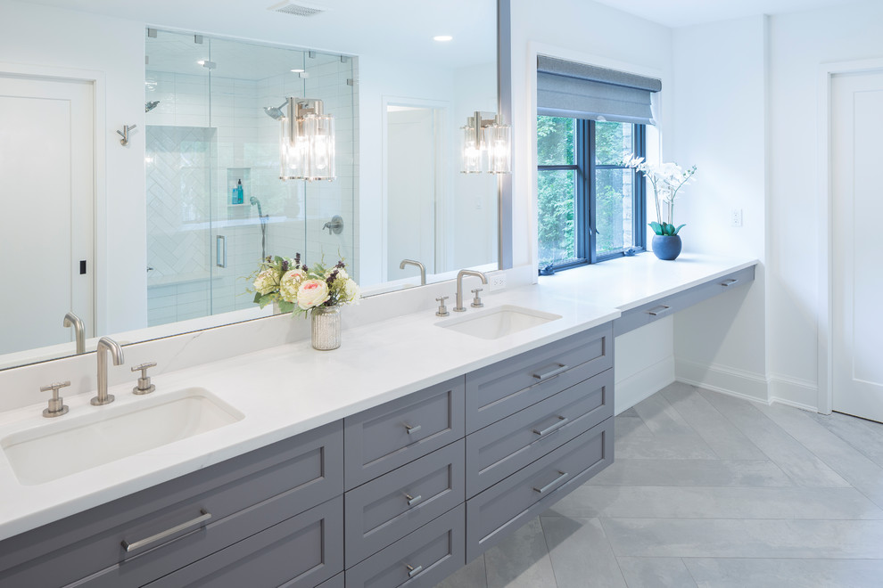 Inspiration for a large contemporary master bathroom in Grand Rapids with shaker cabinets, grey cabinets, mirror tile, white walls, ceramic floors, an undermount sink, engineered quartz benchtops, grey floor and white benchtops.