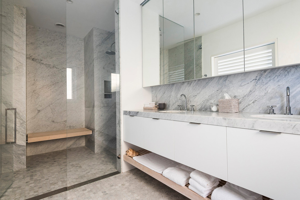 Beach style bathroom in Sydney with flat-panel cabinets, white cabinets, an alcove shower, gray tile, white walls, mosaic tile floors, an undermount sink, grey floor, a hinged shower door and grey benchtops.