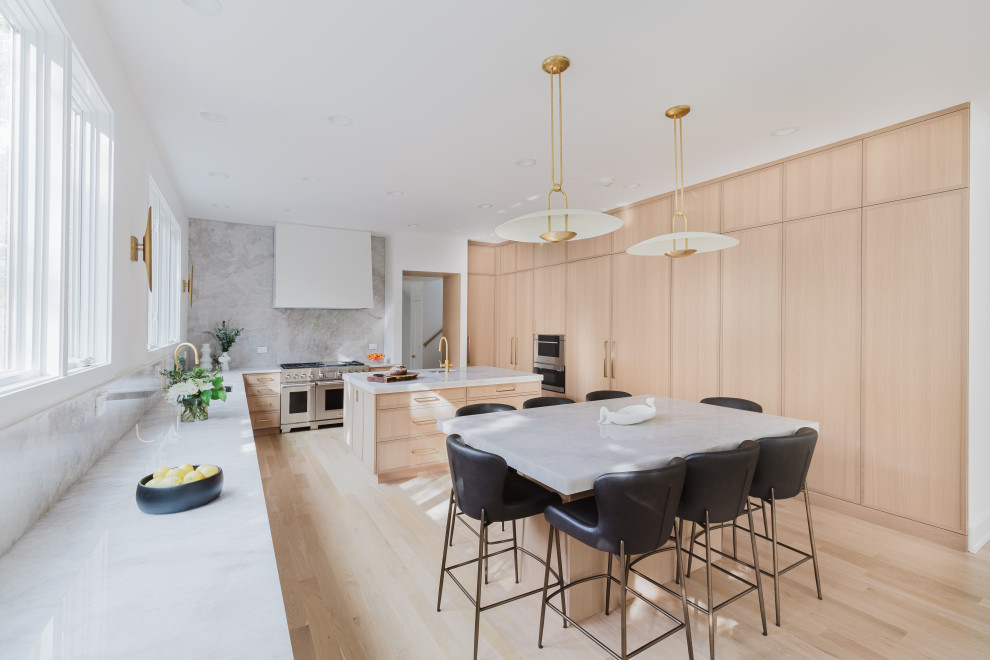 Modern Bright Kitchen With Marble Island and Large Windows Overlooking Greenery