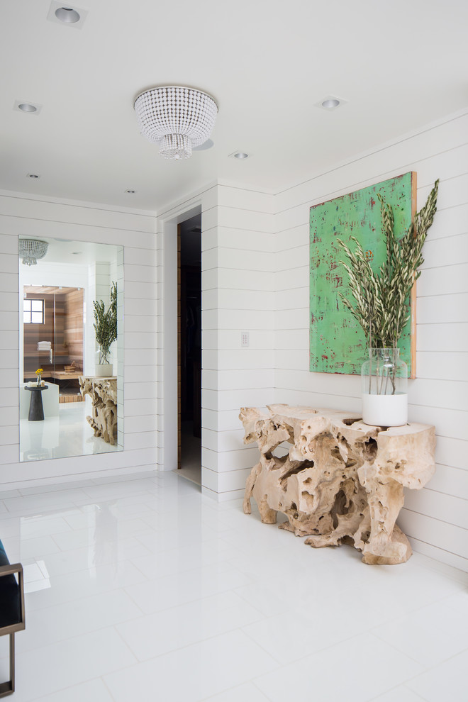 Beach style entryway in Orange County with white walls and white floor.