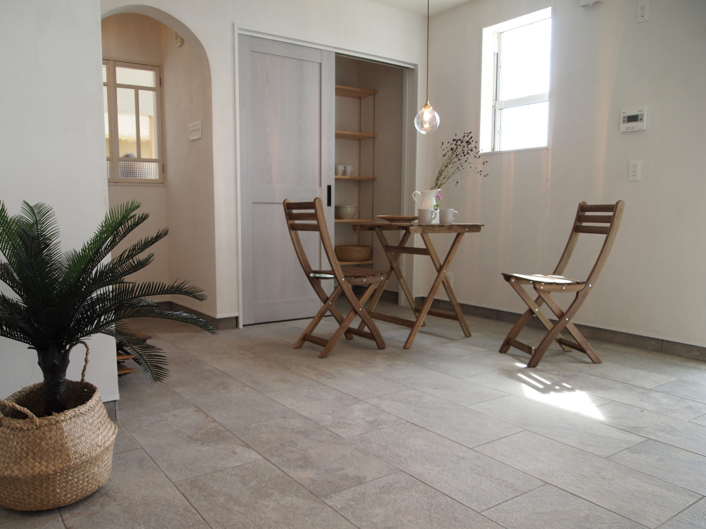 Example of a large mountain style terra-cotta tile and gray floor breakfast nook design in Other with white walls