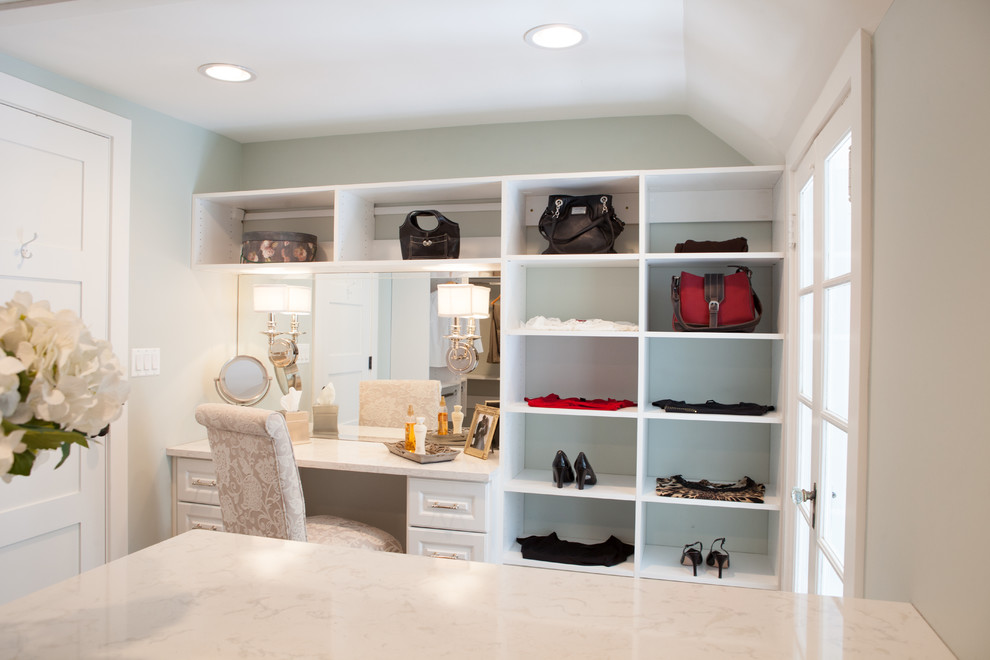 Inspiration for a large country gender-neutral dressing room in Chicago with white cabinets, medium hardwood floors and raised-panel cabinets.
