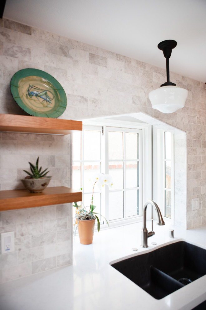 Mid-sized transitional l-shaped ceramic tile and gray floor enclosed kitchen photo in Orange County with an undermount sink, shaker cabinets, blue cabinets, quartz countertops, gray backsplash, marble backsplash, stainless steel appliances, an island and white countertops