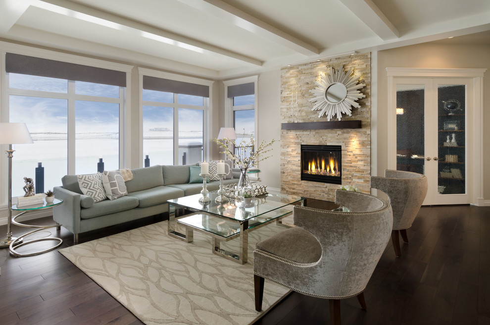 Photo of a contemporary living room in Calgary with a stone fireplace surround.